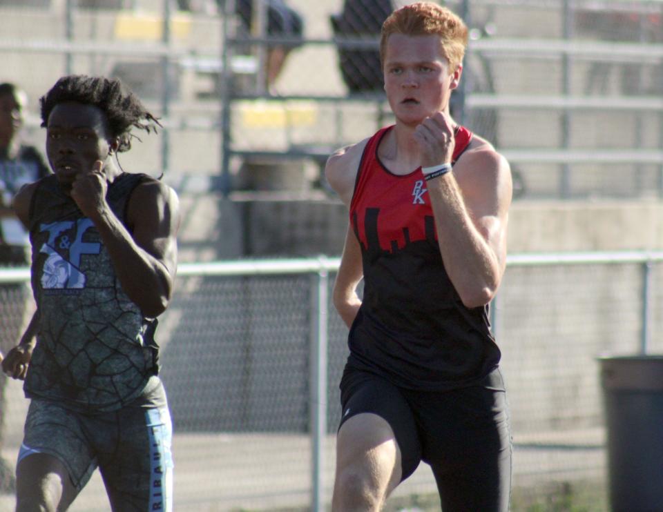 Ribault's Amos Oruamabo (left) and Bishop Kenny's James Resar race side-by-side in the boys 100-meter dash during the FHSAA District 4-2A track meet. Resar won by three-hundredths of a second.