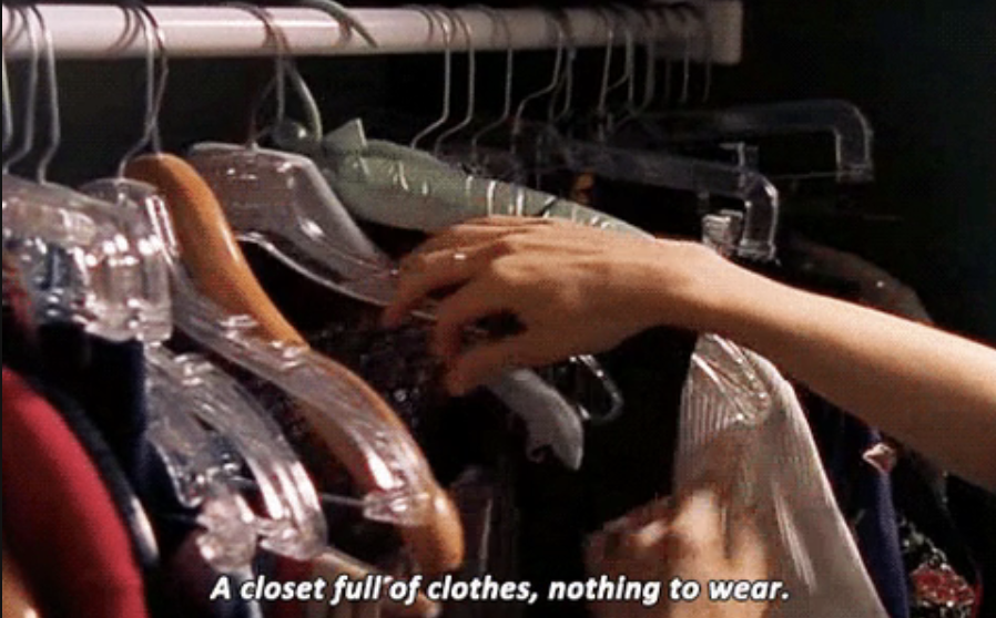 a hand going throw a rack of clothes with text, a closet full of clothes, nothing to wear