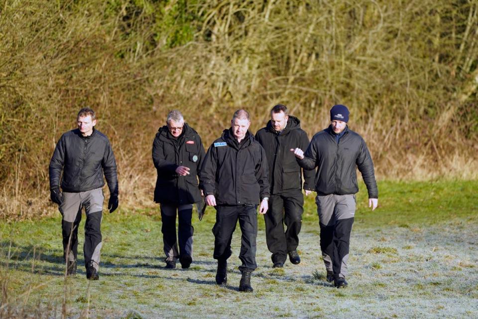 Police officers and the specialist dive team  in St Michael’s on Wyre, Lancashire, on Monday (PA)