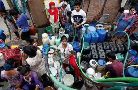 Residents fill their containers with drinking water from a municipal tanker in New Delhi, India, June 26, 2018. REUTERS/Adnan Abidi