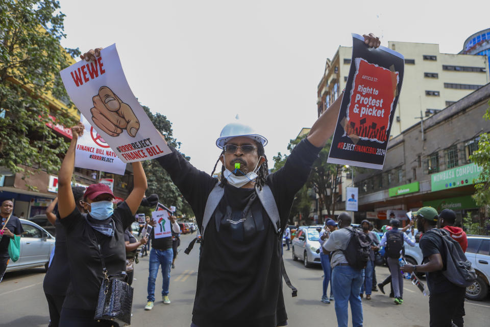 Demonstrators protest against proposed tax hikes in a finance bill that is due to be tabled in parliament in Nairobi, Kenya, Tuesday, June 18, 2024. Civil society groups say that despite the dozens of arrests, demonstrations and a planned sit-down outside the parliament buildings will continue. (AP Photo/Andrew Kasuku)
