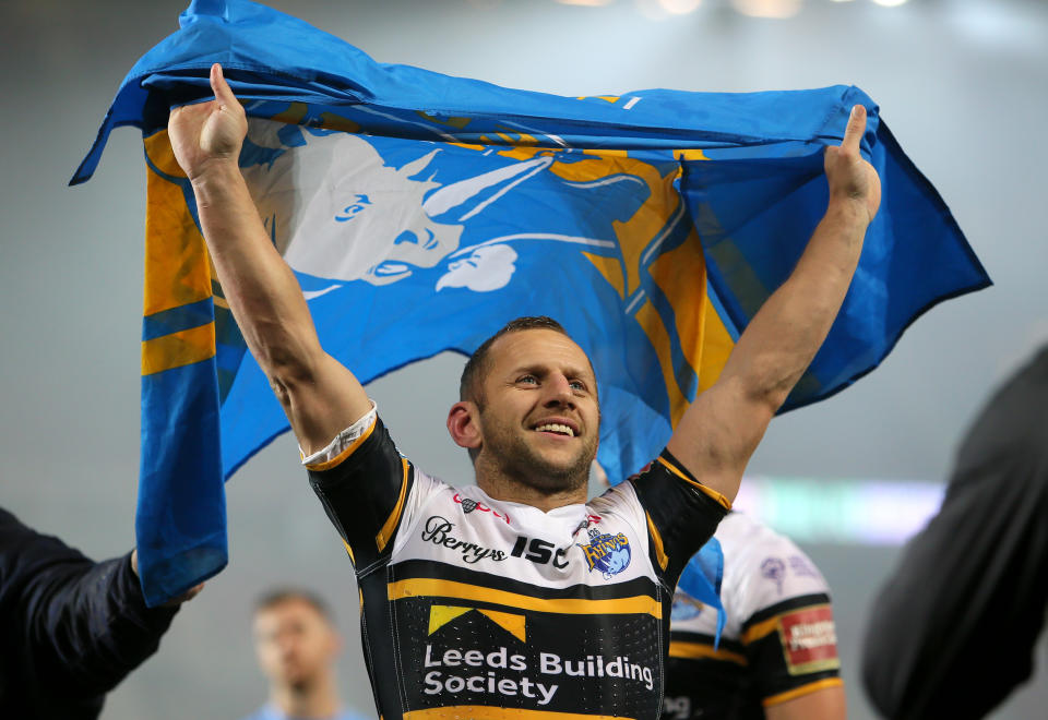 Leeds Rhinos' Rob Burrow celebrates with a flag after the final whistle during the Betfred Super League Grand Final at Old Trafford, Manchester.