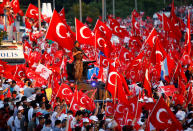 <p>People wave Turkey’s national flags as they attend a ceremony marking the first anniversary of the attempted coup at the Bosphorus Bridge in Istanbul, Turkey, July 15, 2017. (Photo: Murad Sezer/Reuters) </p>