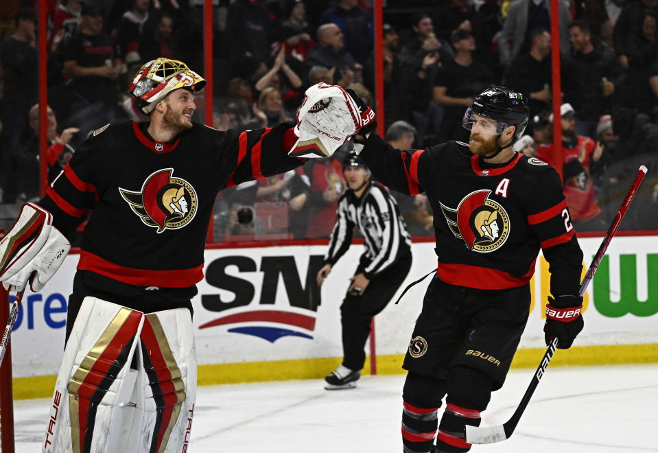 Ottawa Senators right wing Claude Giroux (28) celebrates his goal against the San Jose Sharks with goaltender Anton Forsberg (31) during third-period NHL hockey game action in Ottawa, Ontario, Saturday, Dec. 3, 2022. (Justin Tang/The Canadian Press via AP)