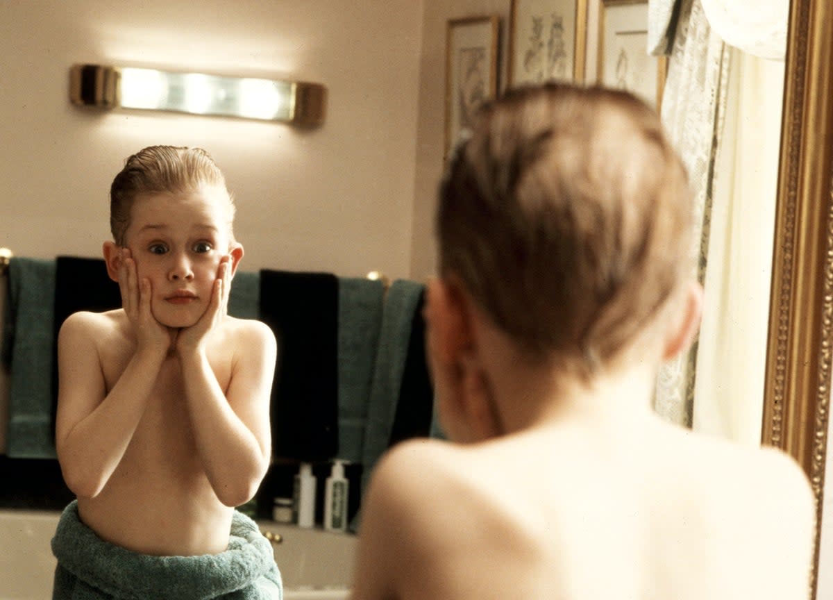 Macaulay Culkin played the doe-eyed eight-year-old Kevin who is left behind in his Chicago home when his family go on holiday to Paris in ‘Home Alone’ (1990) (Rex Features)