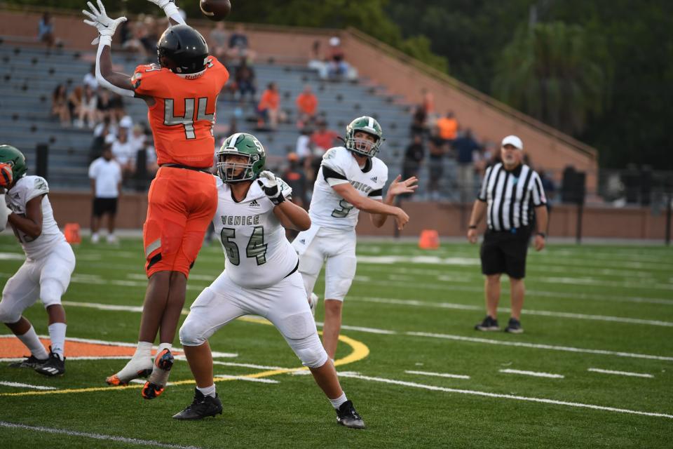 Venice quarterback Brooks Bentley hurls a pass against Lakeland as Tyler Jefferson attempts to block the attempt in a spring contest.