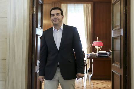 Former Greek Prime Minister Alexis Tsipras stands at his office door inside the Maximos Mansion, before a meeting with the Archbishop of Albania, Anastasios, (unseen) in Athens, Greece August 25, 2015. REUTERS/Costas Baltas/Intimenews