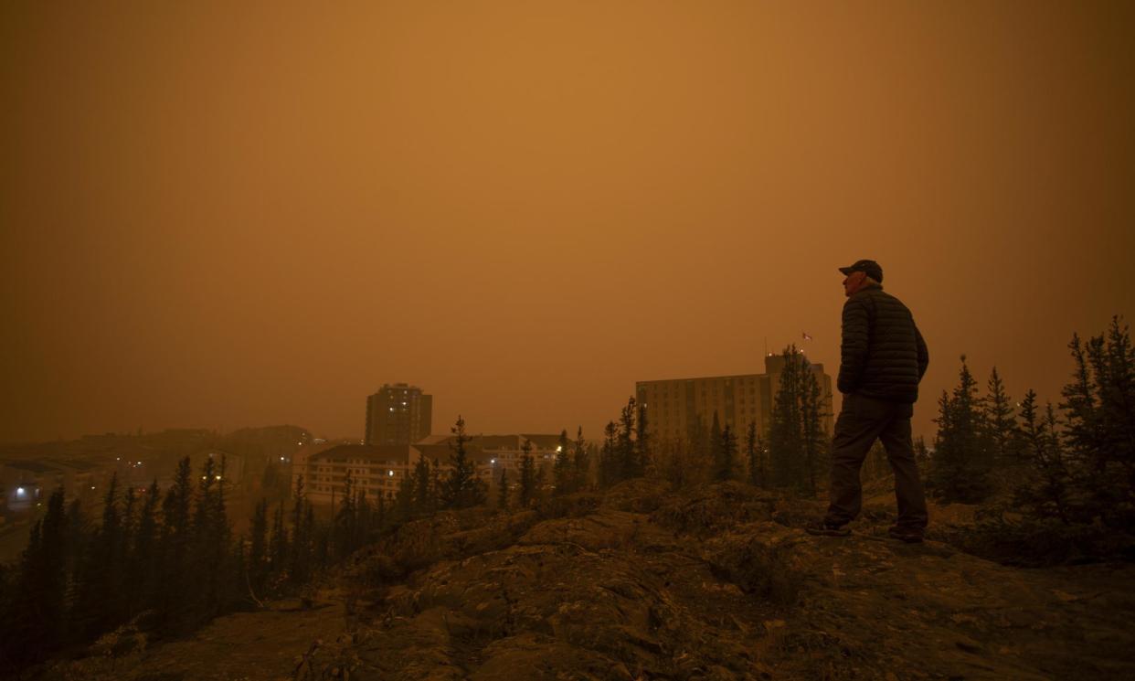 <span>Heavy smoke from wildfires in northern Alberta and British Columbia fill the air in Yellowknife, Northwest Territories on 23 September 2023.</span><span>Photograph: Canadian Press/Shutterstock</span>