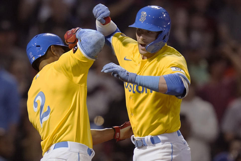 Boston Red Sox's Trevor Story, right, is congratulated by Xander Bogaerts (2) after his three run home run off Detroit Tigers starting pitcher Beau Brieske during the fourth inning of a baseball game, Tuesday, June 21, 2022, at Fenway Park in Boston. (AP Photo/Charles Krupa)