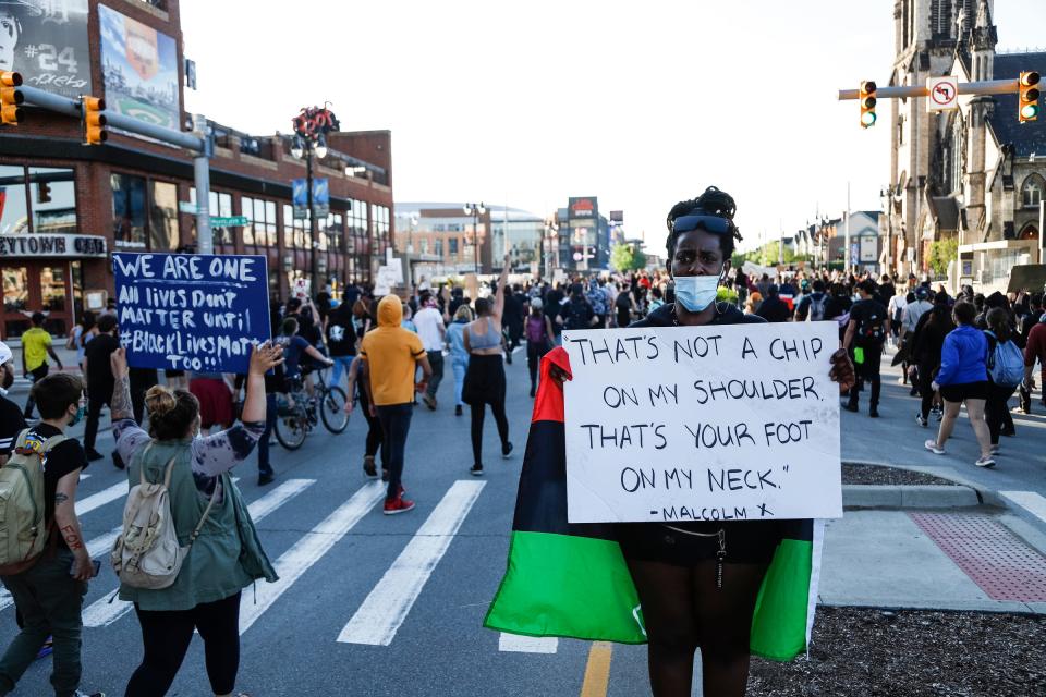 Hundreds march on Woodward Avenue to protest police brutality and the death of George Floyd in Detroit, Friday, May 29, 2020.