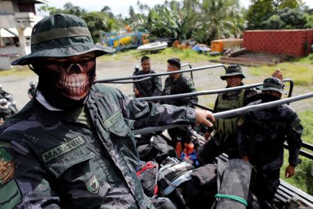 Members of the Philippine National Police Special Action Force ride on a truck in Iligan, as government forces continue their assault against insurgents from the Maute group, who have taken over large parts of Marawi City, Philippines. REUTERS/Jorge Silva