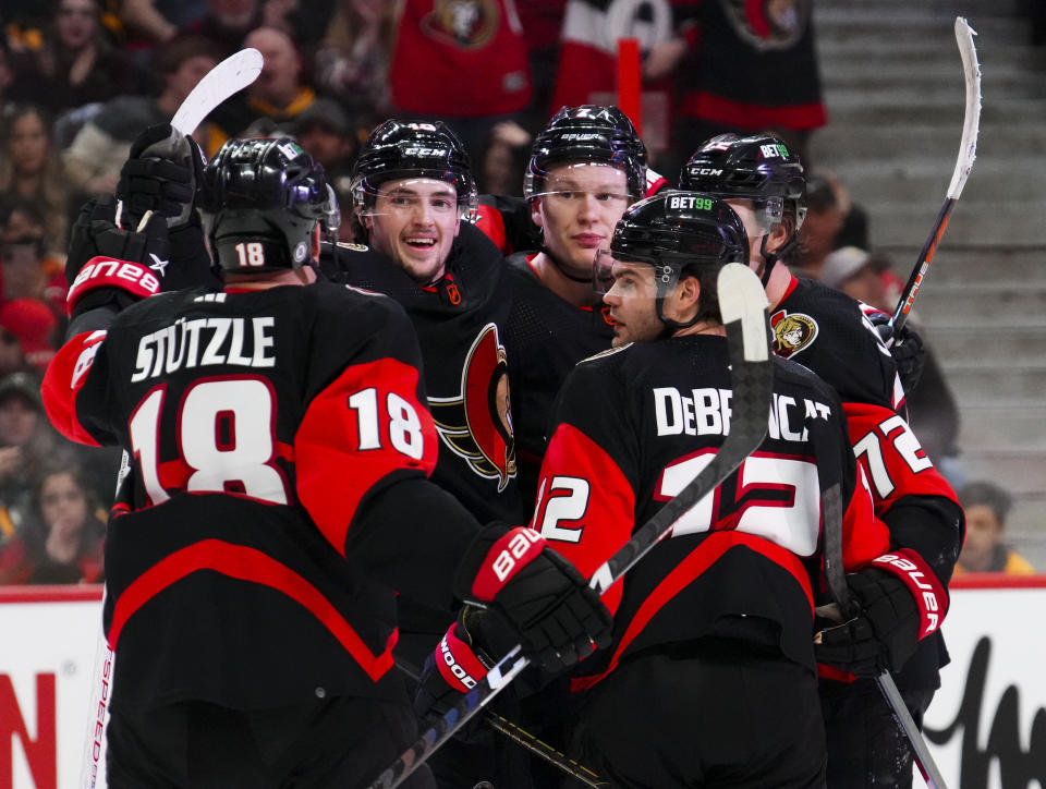 Ottawa Senators right wing Drake Batherson, back left, celebrates his goal against the Pittsburgh Penguins with teammates during the second period of an NHL hockey game Wednesday, Jan. 18, 2023, in Ottawa, Ontario. (Sean Kilpatrick/The Canadian Press via AP)