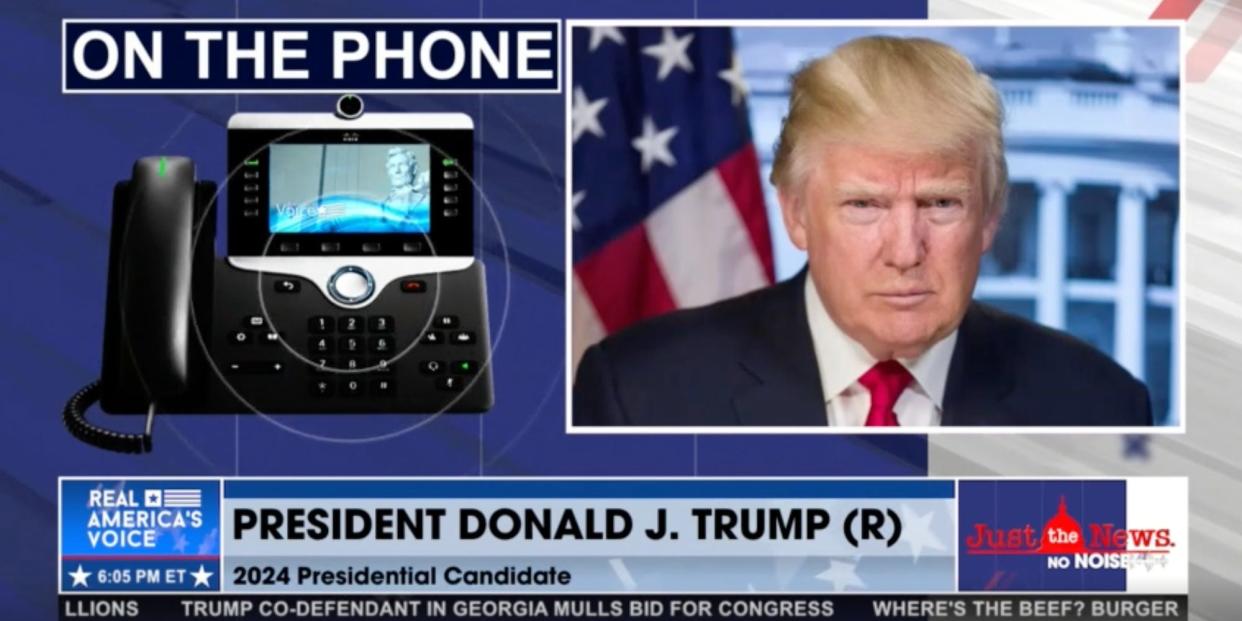 A screenshot from an interview on Real America's Voice, showing a picture of a telephone and a still image of former President Donald Trump, streamed August 31, 2023. A chyron identifies the caller as Trump.