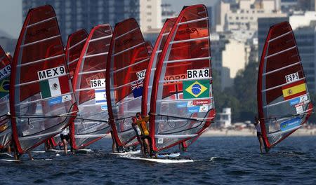 Competitors stand on their windsurfing boards at the women's RS-X sailing class during the first test event for the Rio 2016 Olympic Games at the Guanabara Bay in Rio de Janeiro August 3, 2014. REUTERS/Sergio Moraes