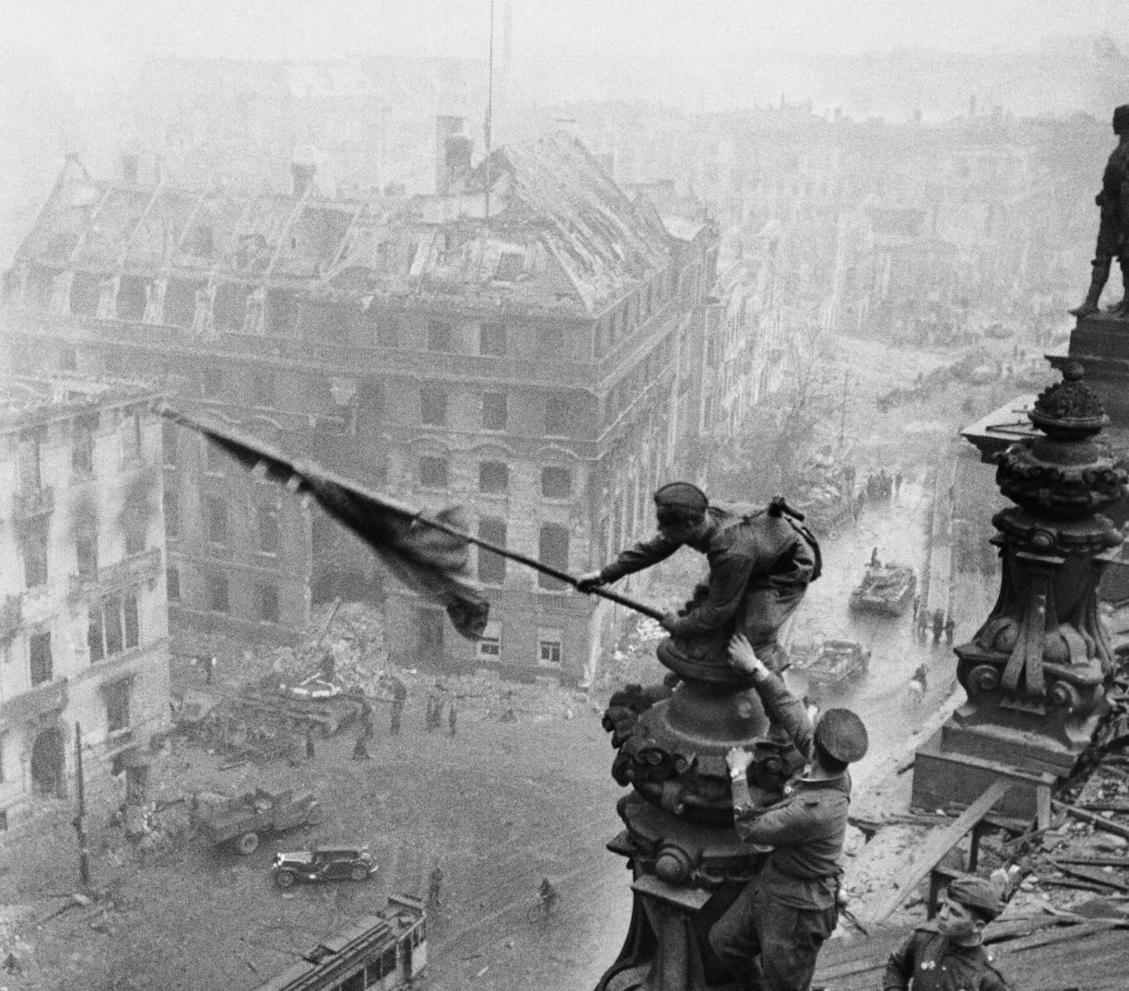 <span>Yevgeny Khaldei’s original image of the Soviet flag being raised over the Reichstag, Berlin, 1945, above, was later amended to obscure the officer wearing a watch on both wrists.</span><span>Photograph: Sovfoto/Universal Images Group/Shutterstock</span>