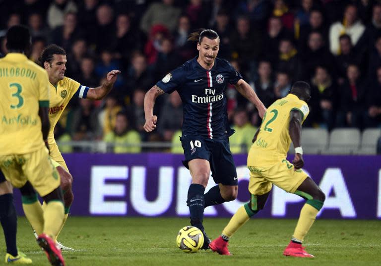 Paris Saint-Germain's Swedish midfielder Zlatan Ibrahimovic (C) vies with Nantes' French defender Issa Cissokho (R) during their French L1 football match on May 3, 2015 in Nantes, France