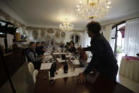 In this image taken on Monday, Oct. 15, 2018, expert manager of Giusti Wine Sebastiano Bonomo opens a Prosecco bottle during a wine testing at the Giusti Wine farm, in Montello, Italy. Prosecco has become the best-selling sparkling wine in the world, and experts say it is eroding the more casual corner of champagne's market while aiming higher. Its production eclipsed champagne's five years ago and is now 75 percent higher at 544,000 bottles three-quarters of which for export. (AP Photo/Luca Bruno)