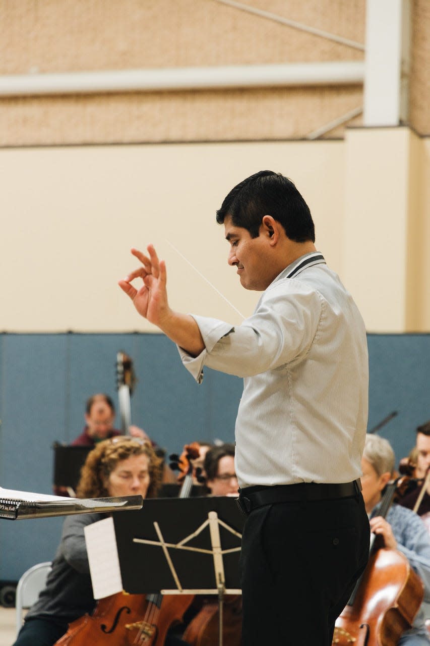 Isaac Terceros conducts the Bloomington Symphony Orchestra during a recent practice session. The orchestra will present Un Voyage Francais in a concert May 12 at the Buskirk-Chumley Theater.