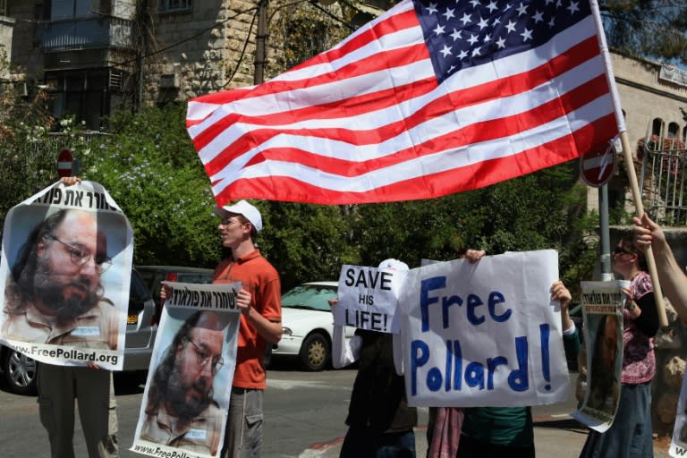 Israeli activists hold up pictures of Jonathan Pollard during a protest calling for his release, in Jerusalem on August 17, 2011