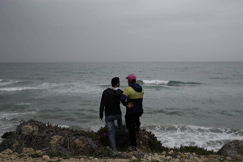 Ahmed Ayouby, 32, left, and Mounir Aguida, 30, who want to leave Tunisia, stand at the beach where migrants leave for Italy, in the town of Ras Jabal, Bizerte, Tunisia, on April 14, 2018. In late August 2018, he crammed into a raft with seven friends, feeling the waves slam the flimsy bow. At the last minute he and another young man jumped out. “It didn’t feel right,” Aguida said. There has been no word from the other six. (AP Photo/Nariman El-Mofty)