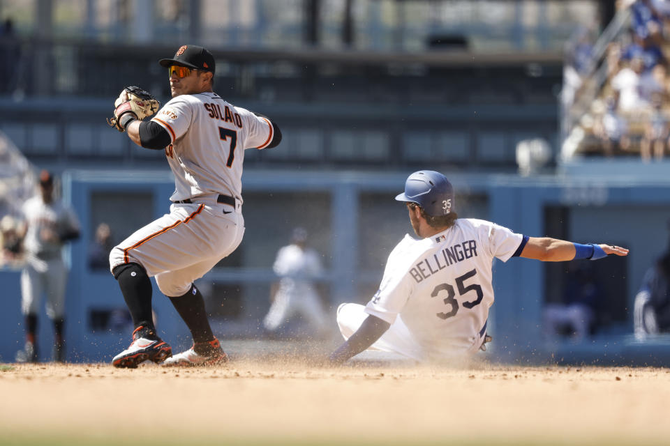 Cody Bellinger of the Los Angeles Dodgers slides into second base as Donovan Solano of the San Francisco Giants attempts to throw to first for a double play. (Photo by Michael Owens/Getty Images)