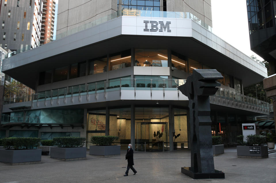 A man wearing a protective mask walks past an office building with IBM logo amidst the easing of the coronavirus disease (COVID-19) restrictions in the Central Business District of Sydney, Australia, June 3, 2020. Picture taken June 3, 2020. (Photo: REUTERS/Loren Elliott)