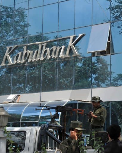 File photo of Afghan security guards keeping watch outside the main branch of the Kabul Bank, in Kabul. The near-collapse in 2010 of the Kabul Bank, the country's biggest private lender responsible for paying 80 percent of government employees came to symbolise the extent of the country's graft problem