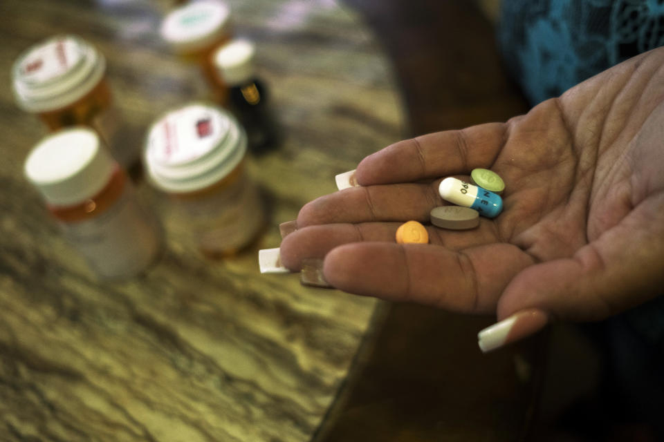 In her home, Rivera Acosta takes medication for her kidney failure and hypertension.&nbsp; (Photo: Dennis M. Rivera Pichardo for HuffPost)