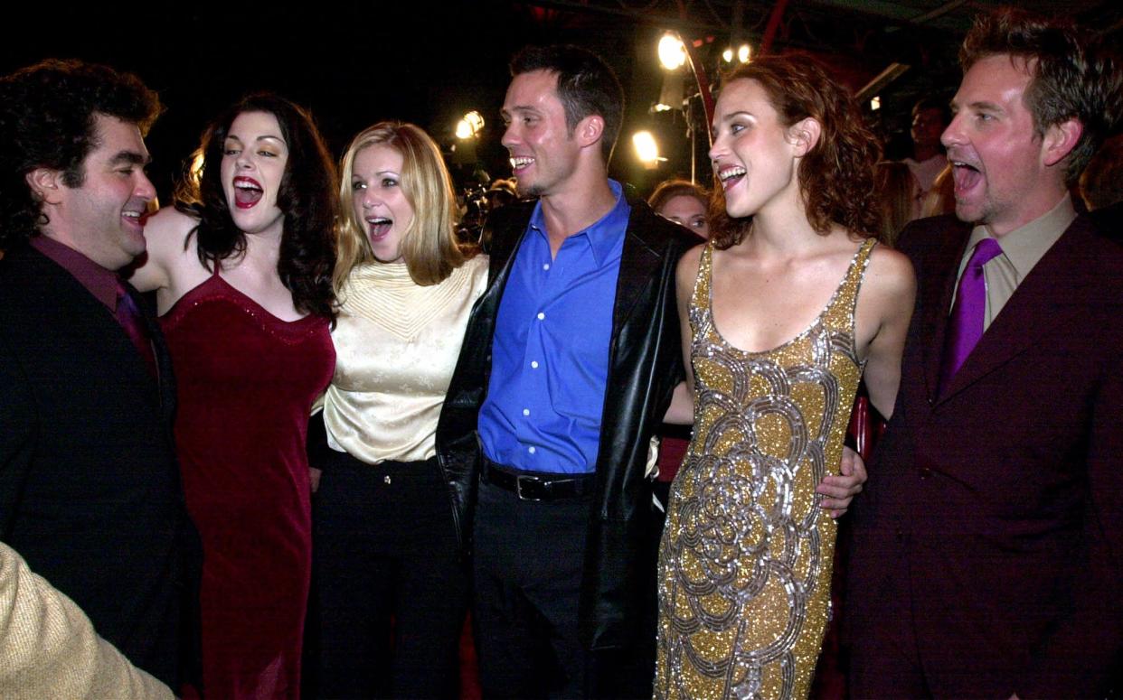 Cast of 'Book of Shadows Blair Witch 2' greet director, Joe Berlinger, left, before the premiere of the movie in Los Angeles, Monday, Oct. 23, 2000. The cast members are; Kim Director, second from left, Tristen Skyler, Jeff Donovan, Erica Leerhsen and Stephen Barker Turner. (AP Photo/Kim Johnson)