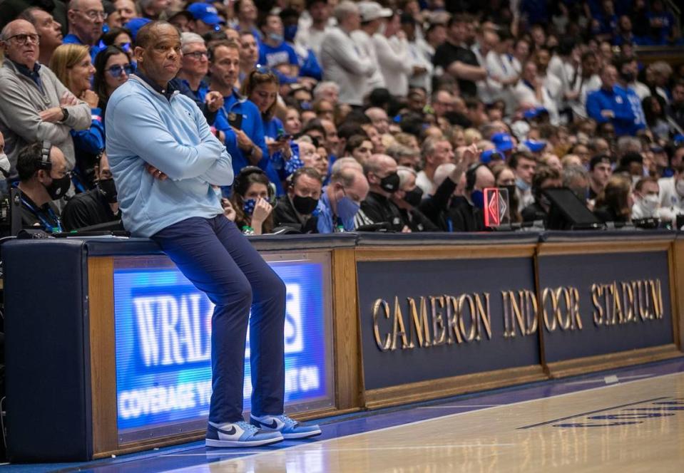 North Carolina coach Hubert Davis takes a seat on the scorers table at Cameron Indoor Stadium as he waits for play to resume following a time-out on Saturday, March 5, 2022 in Durham, N.C.