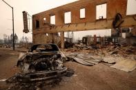 Burned out car and commercial building at the Dixie Fire in Greenville