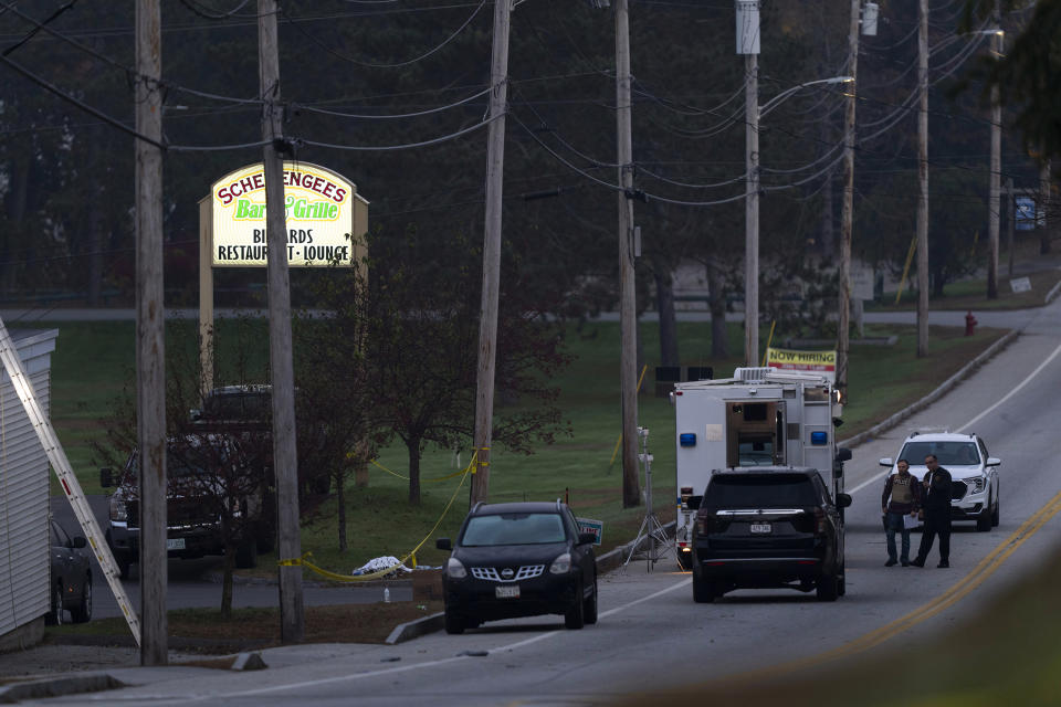Investigators are outside Schemengees Bar and Grille in the aftermath of a mass shooting in Lewiston, Maine, Friday, Oct. 27, 2023. Shocked and fearful Maine residents are keeping to their homes for a second night as hundreds of police and FBI agents search intently for Robert Card, a U.S. Army reservist authorities say fatally shot several people at a bowling alley and a bar. (AP Photo/Matt Rourke)