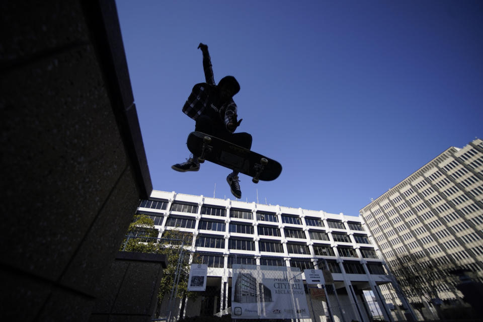 Skateboarder Kam Blakely skates in front of city hall in remembrance of Tyre Nichols, who died after being beaten by Memphis police officers, five of whom have been fired, in Memphis, Tenn., Monday, Jan. 23, 2023. Tyre was a member of the skateboarding community, and they gathered at the request of Tyre's family to honor him. (AP Photo/Gerald Herbert)