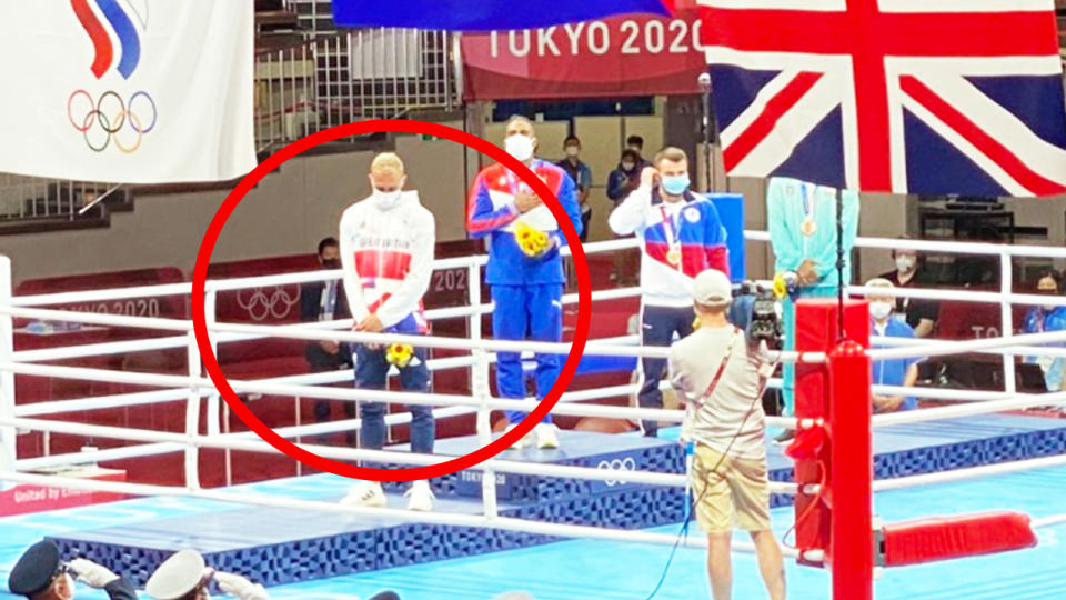 British boxer Ben Whittaker (pictured left) not wearing his silver medal on the podium at the Tokyo Olympic Games.