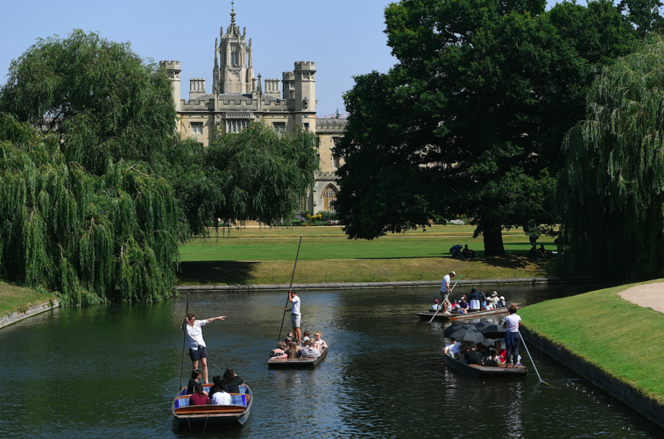 People punt past St. John's College on the River Cam in Cambridge (PA)