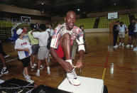 Michael Jordan ties his shoe at the 1992 Summer Olympics in Barcelona, Spain. (Photo by Andrew D. Bernstein/NBAE via Getty Images)