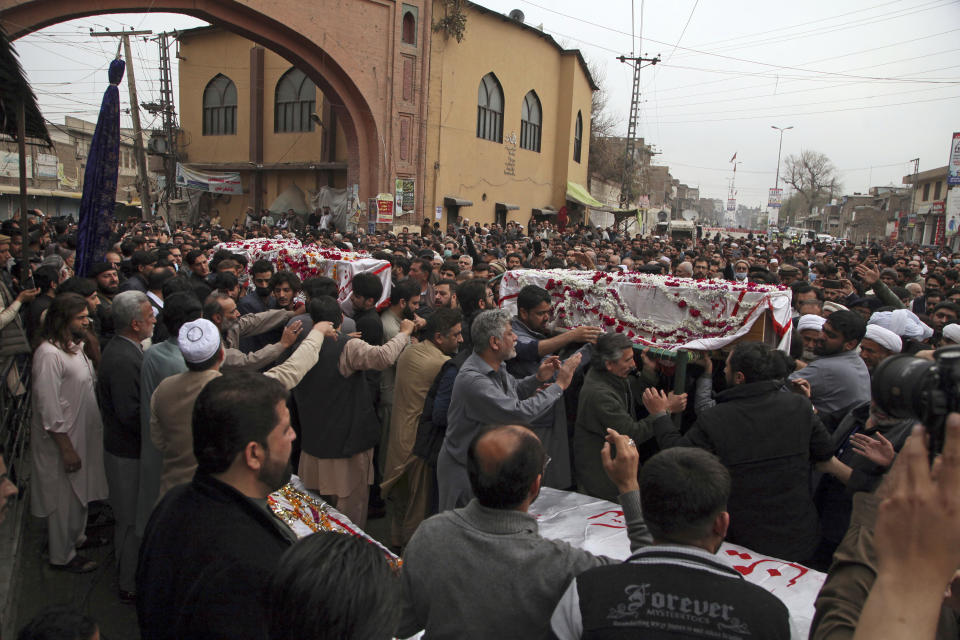 People carry the coffins of the victims in Friday's suicide bombing in Peshawar, Pakistan, Saturday, March 5, 2022. The Islamic State says a lone Afghan suicide bomber struck inside a Shiite Muslim mosque in Pakistan's northwestern city of Peshawar during Friday prayers, killing dozens worshippers and wounding more than 190 people. (AP Photo/Muhammas Sajjad)