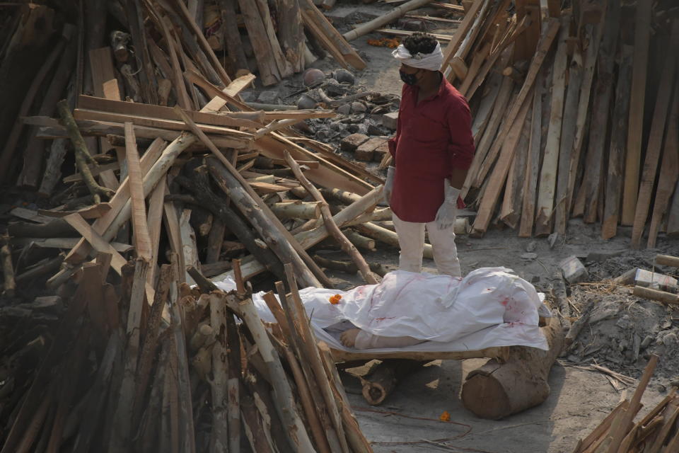 Family members and relatives perform last rites of Covid-19 victims during mass cremation at Gazipur crematorium in New Delhi, India. Source:Pacific Press/Sipa USA