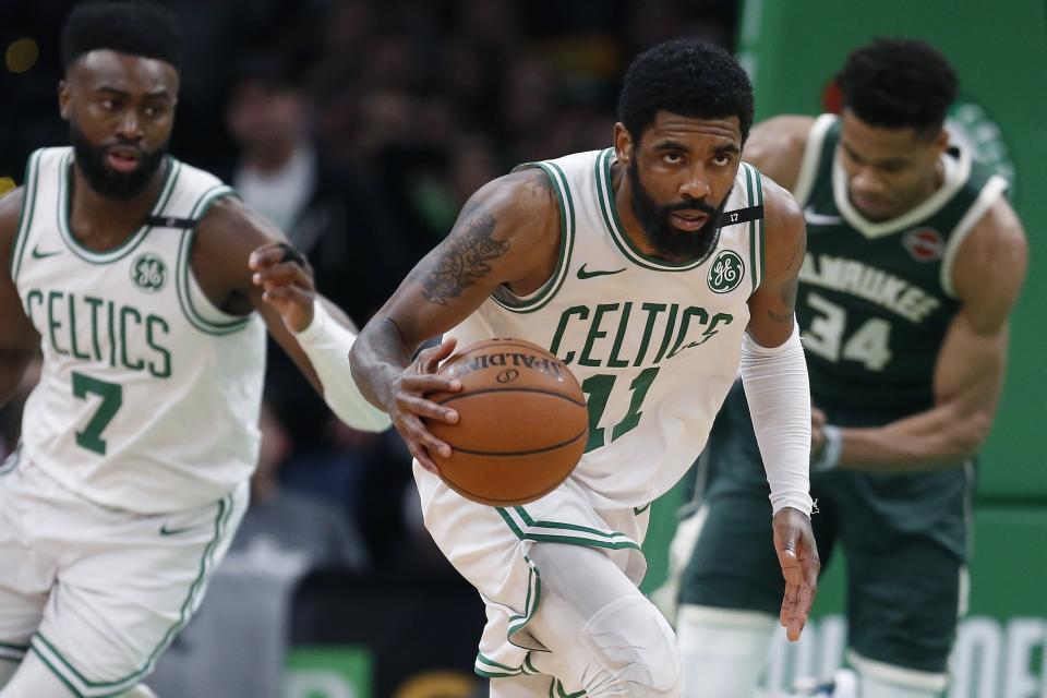 FILE - In this May 6, 2019, file photo, Boston Celtics' Kyrie Irving (11) brings the ball upcourt during the second half of Game 4 of a second-round NBA basketball playoff series against the Milwaukee Bucks in Boston. Irving and Kevin Durant gave the Brooklyn Nets two big victories in one night. In the first hours of free agency, the team added two of the best players available to a young roster that made the playoffs, giving them hope of not only contention for an NBA title, but to be the biggest basketball team in New York. (AP Photo/Michael Dwyer, File)