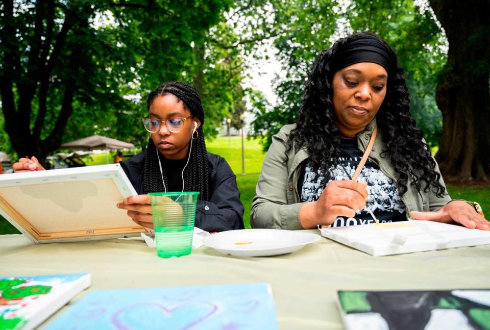 Latisha Conley and her daughter, Larrisa Conley, paint at the third annual Juneteenth celebration at Wright Park in Tacoma, Wash. on Saturday, June 18, 2022. Cheyenne Boone/cboone@thenewstribune.com