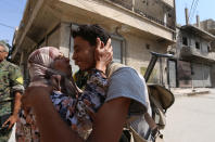 <p>A woman approches a Syria Democratic Forces (SDF) fighter to kiss him after the fighters entered Manbij, in Aleppo Governorate, Syria, Aug. 7, 2016. (REUTERS/Rodi Said) </p>