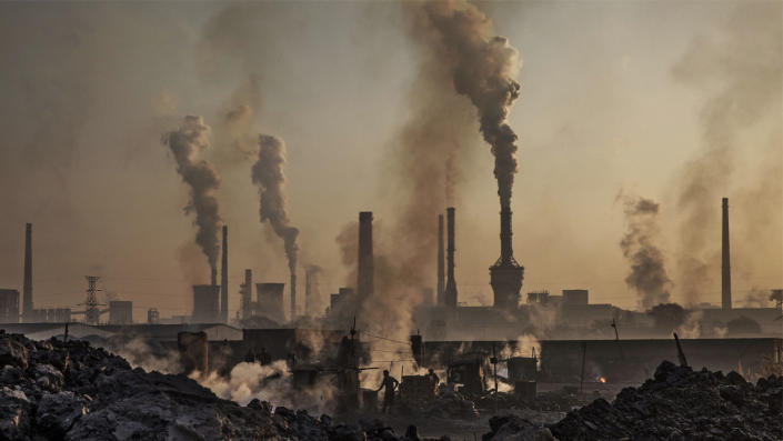 A Chinese laborer is exposed to toxic smoke at an unauthorized steel factory, in Inner Mongolia