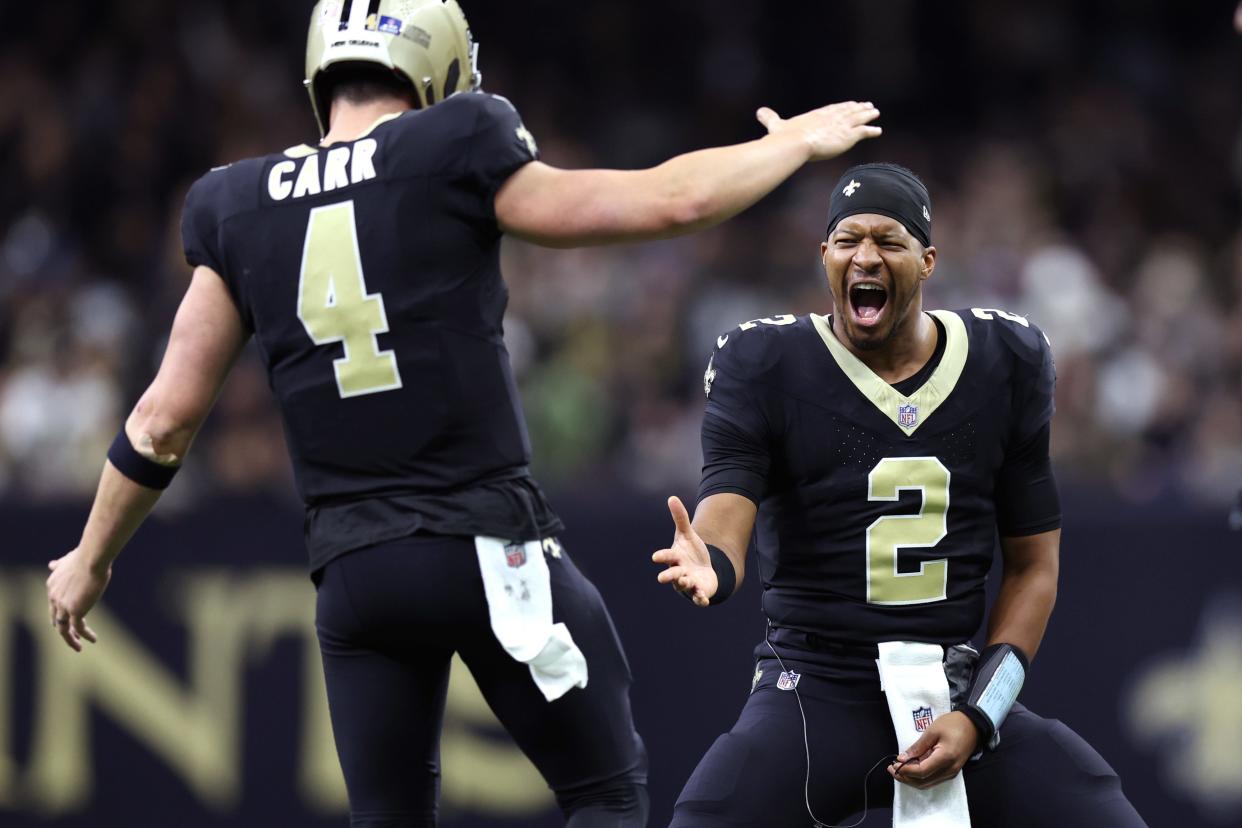 Dec 17, 2023; New Orleans, Louisiana, USA; New Orleans Saints quarterback Derek Carr (4) is congratulated by quarterback Jameis Winston (2) after a touchdown against the New York Giants during the second half at Caesars Superdome. Mandatory Credit: Stephen Lew-USA TODAY Sports