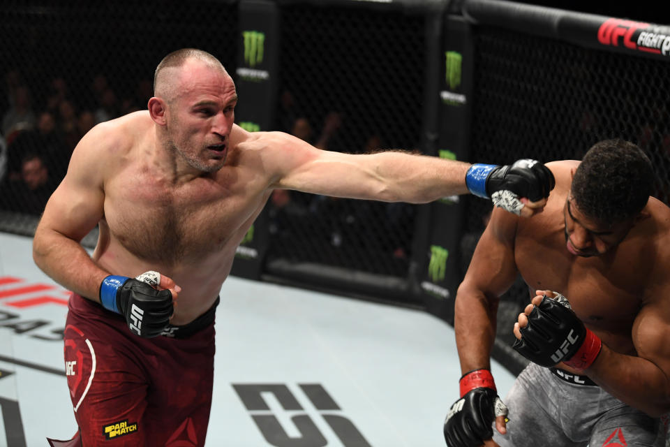 SAINT PETERSBURG, RUSSIA - APRIL 20:  (L-R) Aleksei Oleinik of Russia punches Alistair Overeem of The Netherlands in their heavyweight bout during the UFC Fight Night event at Yubileyny Sports Palace on April 20, 2019 in Saint Petersburg, Russia. (Photo by Jeff Bottari/Zuffa LLC/Zuffa LLC via Getty Images)