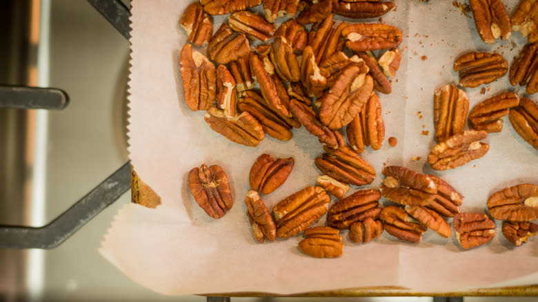 Toasted pecans on parchment paper