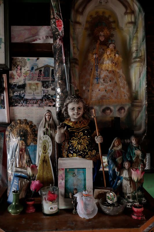 The Wider Image: Rising seas threaten early end for sinking village in Philippines