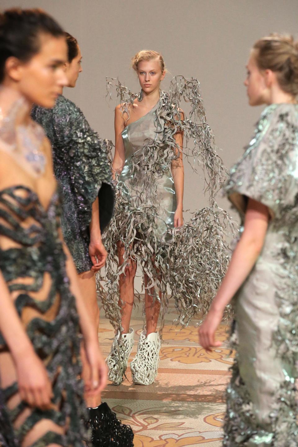 Models wear creations of Dutch designer Iris van Herpen for the Haute Couture Fall-Winter 2013-2014 collection, Monday, July 1, 2013 in Paris. (AP Photo/Michel Euler)