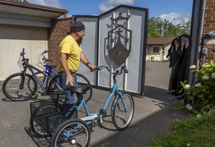 Steven Pringle delivers three bikes as donations to surprised nuns at the Carmelite Monastery of the Holy Cross in Iron Mountain, Michigan, on July 29, 2022.