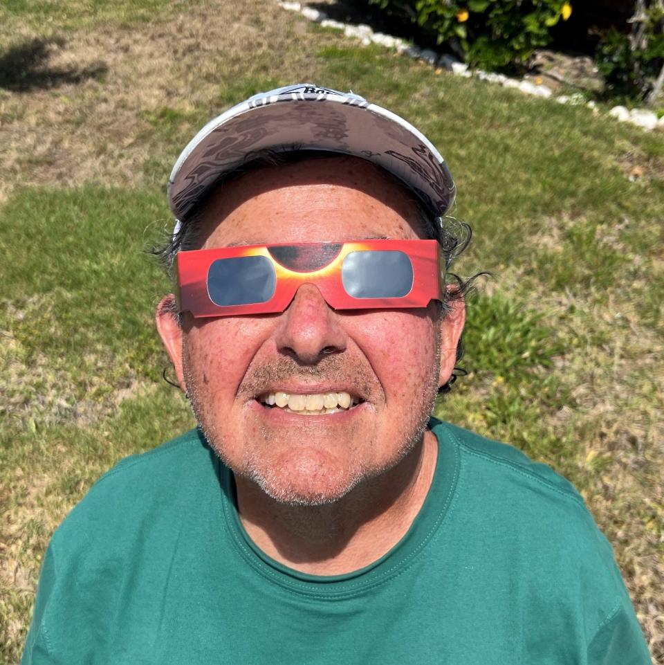 Former FLORIDA TODAY reporter Hillard Grossman tests out his eclipse glasses.