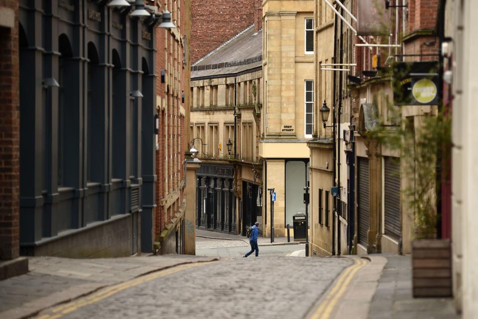 A man walks through a near-deserted centre of Newcastle upon Tyne at Thursday lunchtime in north-east England on April 9, 2020 as Britain continued to battle the outbreak of new coronavirus and the governement prepared to extend the nationwide lockdown. - The disease has struck at the heart of the British government, infected more than 60,000 people nationwide and killed over 7,000, with another record daily death toll of 938 reported on April 8. A testing centre opened in Gateshead on April 9, 2020 as the government ramped up its testing of NHS staff for the new coronavirus. (Photo by Oli SCARFF / AFP) (Photo by OLI SCARFF/AFP via Getty Images)